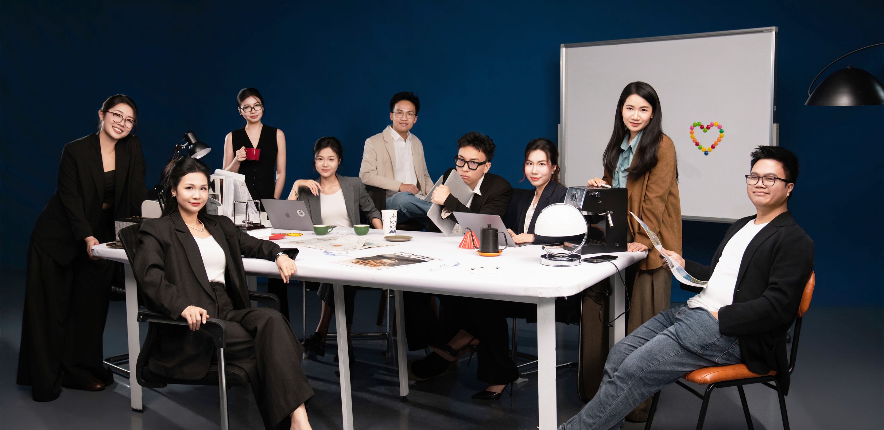 The HG Entertainment team gathered around a meeting table